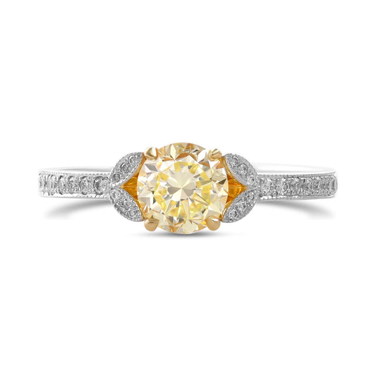 Ring mit gelbem Diamanten im Rundschliff und Pavé-Fassung an den Seiten