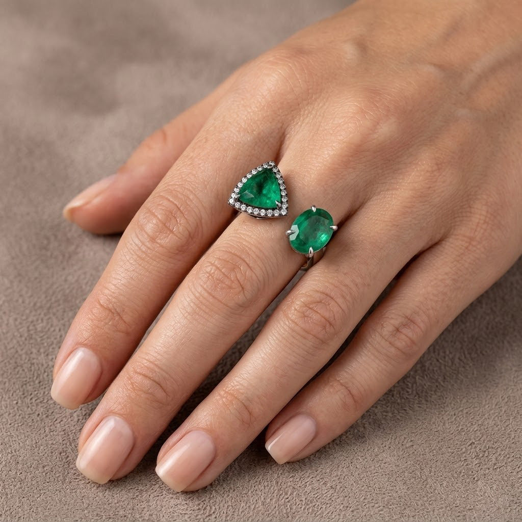 Two-stone Trilliant and Oval Emerald Ring