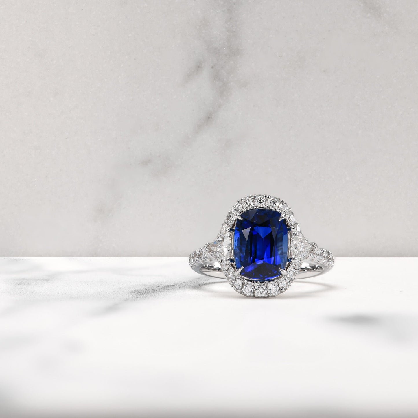 Royal Blue Cushion Sapphire & Triangle Diamond Halo Ring